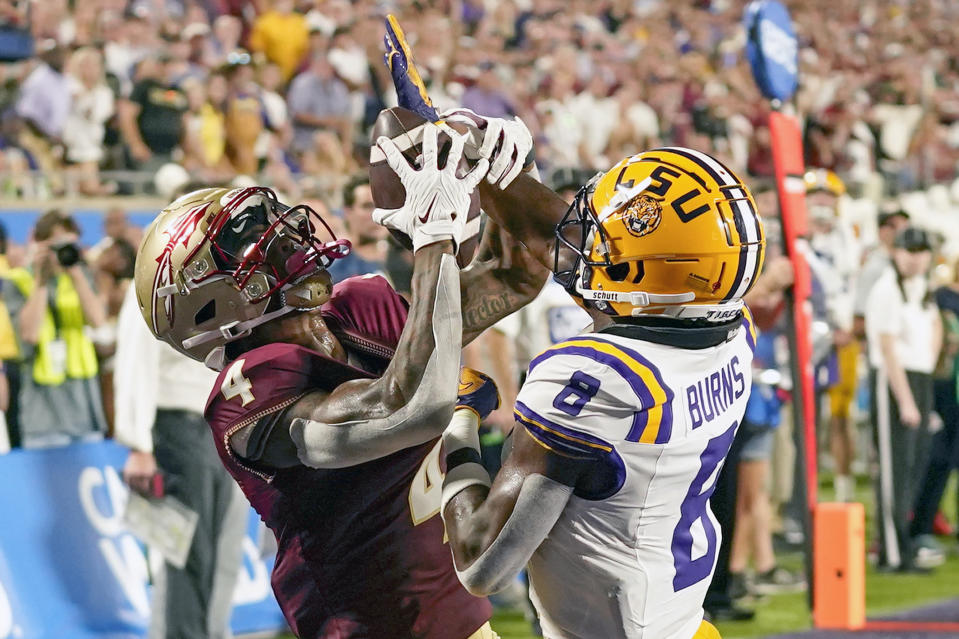 Florida State wide receiver Keon Coleman, left, makes a reception over LSU safety Major Burns (8) for a 21-yard touchdown during the first half of an NCAA college football game Sunday, Sept. 3, 2023, in Orlando, Fla. (AP Photo/John Raoux)