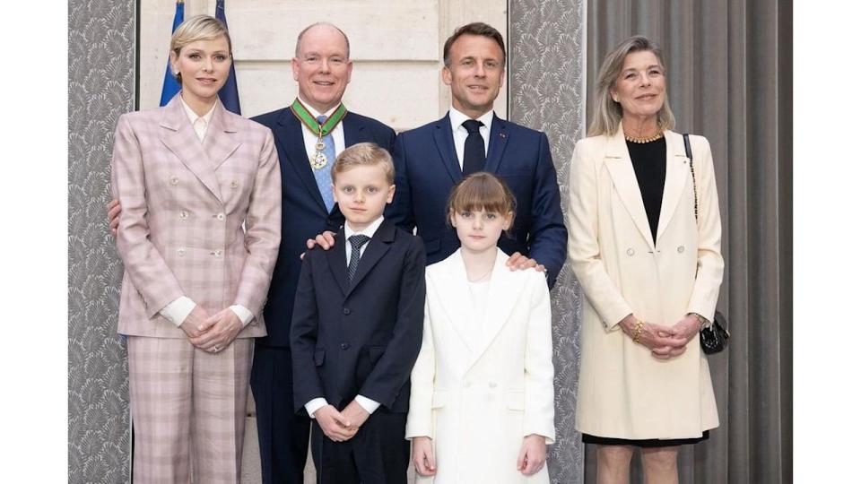 Princess Charlene wears a pink suit next to her husband Prince Albert, their children Jacques and Gabriella, and President Emmanuel Macron