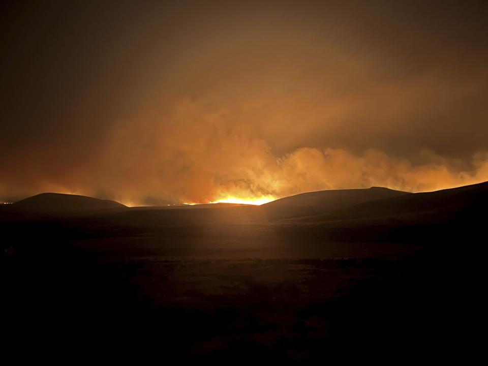 In this photo provided by the Oregon Department of Transportation, the Durkee Fire lights up the sky in eastern Ore., Monday, July 22, 2024. (Oregon Department of Transportation via AP)