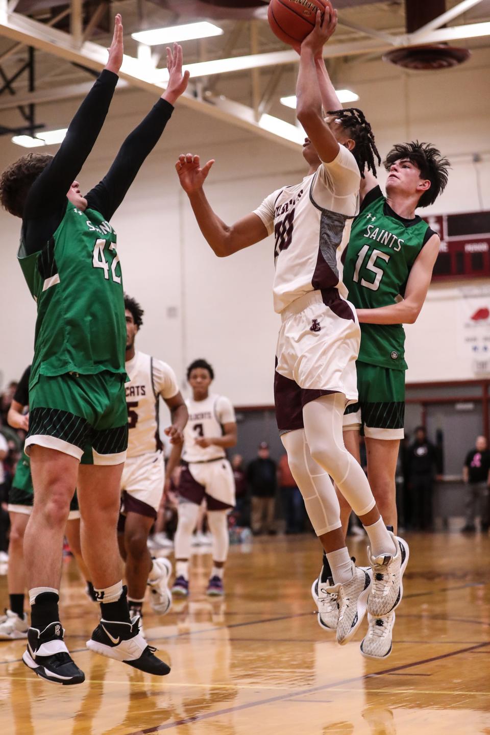 Zubayr Griffin takes the shot for Johnson City as Johnny Hopf and Brian Dempsey defend for Seton Catholic Central in the Wildcats' 66-60 victory in the STAC boys basketball championship game Feb. 16, 2024 at Johnson City High School.