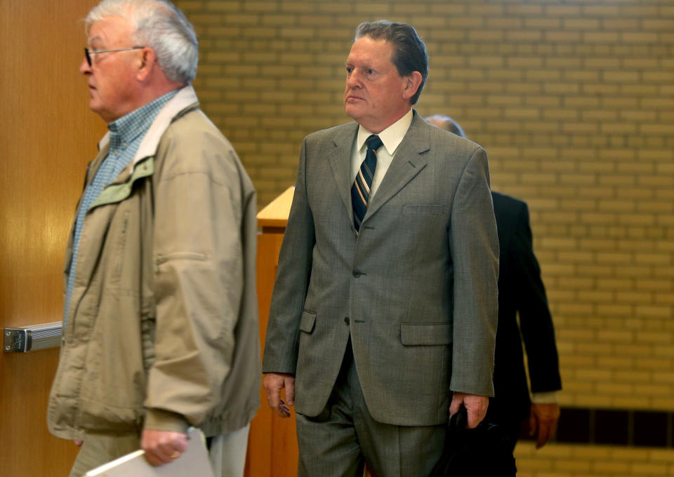 Byron Smith, center, makes his way through security at the Morrison County Courthouse, Monday, April 21, 2014, in Little Fall, Minn. The 65-year-old faces two counts of premeditated first-degree murder for the killings of Haile Kifer, 18, and Nick Brady, 17, who broke into his home on Thanksgiving Day 2012. (AP Photo/The Star Tribune, Elizabeth Flores) MANDATORY CREDIT; ST. PAUL PIONEER PRESS OUT; MAGAZINES OUT; TWIN CITIES TV OUT.