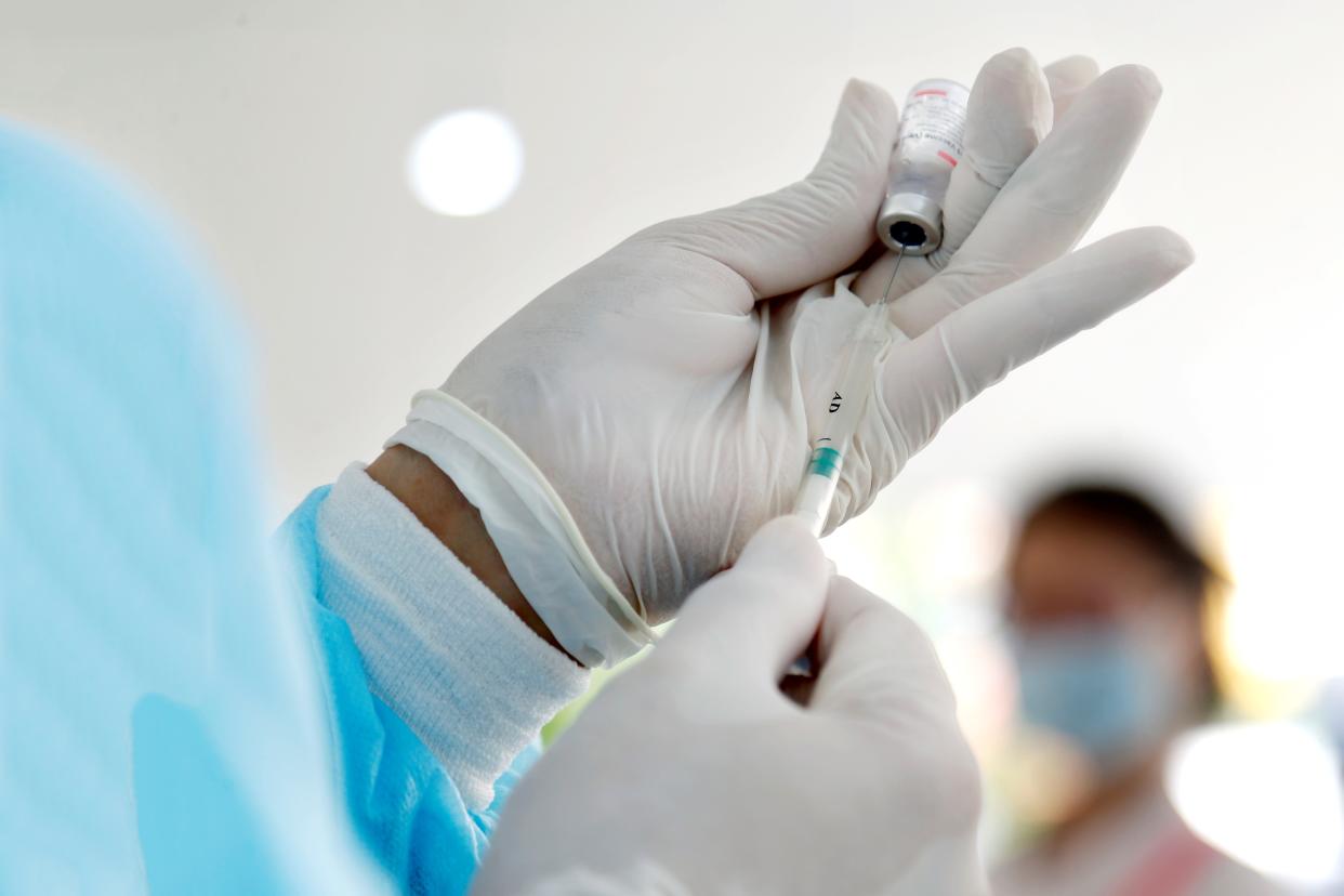 A health worker pumps China's Sinovac COVID-19 vaccine with a syringe at a vaccination site in Phnom Penh, Cambodia on June 1, 2021. (PHOTO: Xinhua via Getty Images)