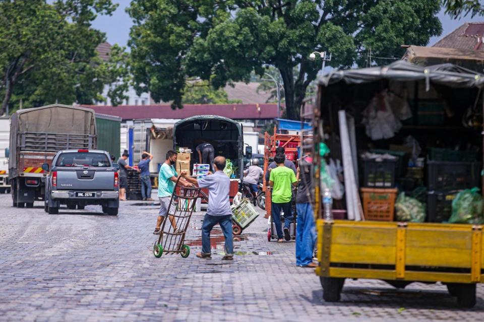 Trucks are seen dropping off fresh produce at the Kuala Lumpur Wholesale Market in Selayang June 24, 2020. ― Picture by Hari Anggara