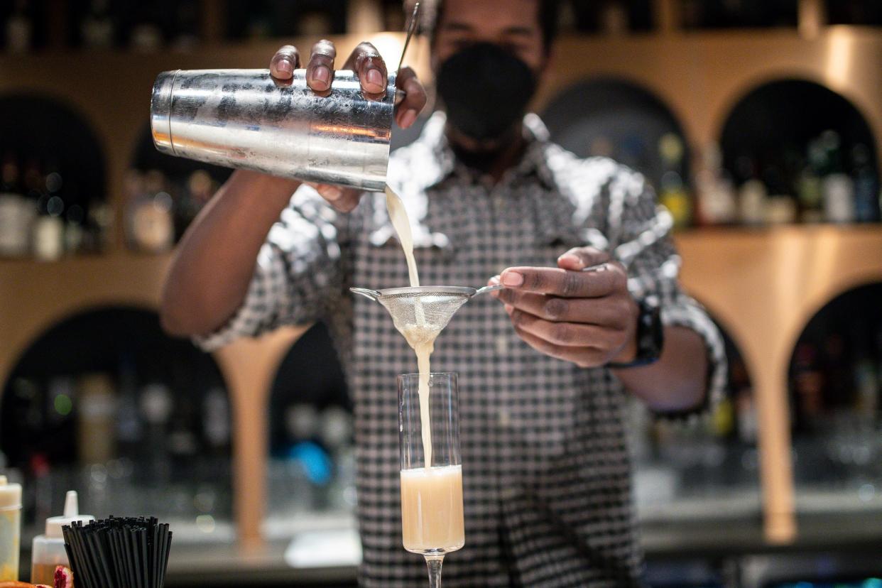 Head bartender Andre Sykes prepare a cocktail at Shelby.