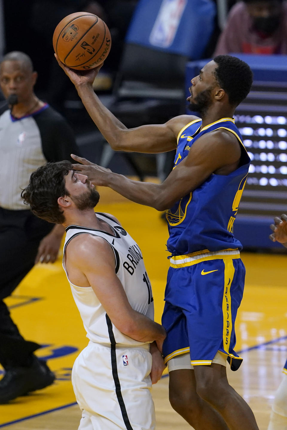 Golden State Warriors forward Andrew Wiggins shoots over Brooklyn Nets forward Joe Harris during the first half of an NBA basketball game in San Francisco, Saturday, Feb. 13, 2021. (AP Photo/Jeff Chiu)