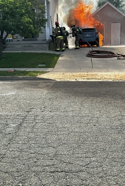 Photos of a car catching fire by a home in Clearfield. (North Davis Fire District Chief Mark Becraft)