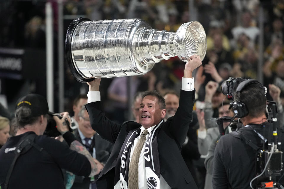 Vegas Golden Knights head coach Bruce Cassidy holds up the Stanley Cup after the Knights defeated the Florida Panthers 9-3 in Game 5 of the NHL hockey Stanley Cup Finals Tuesday, June 13, 2023, in Las Vegas. The Knights won the series 4-1. (AP Photo/John Locher)