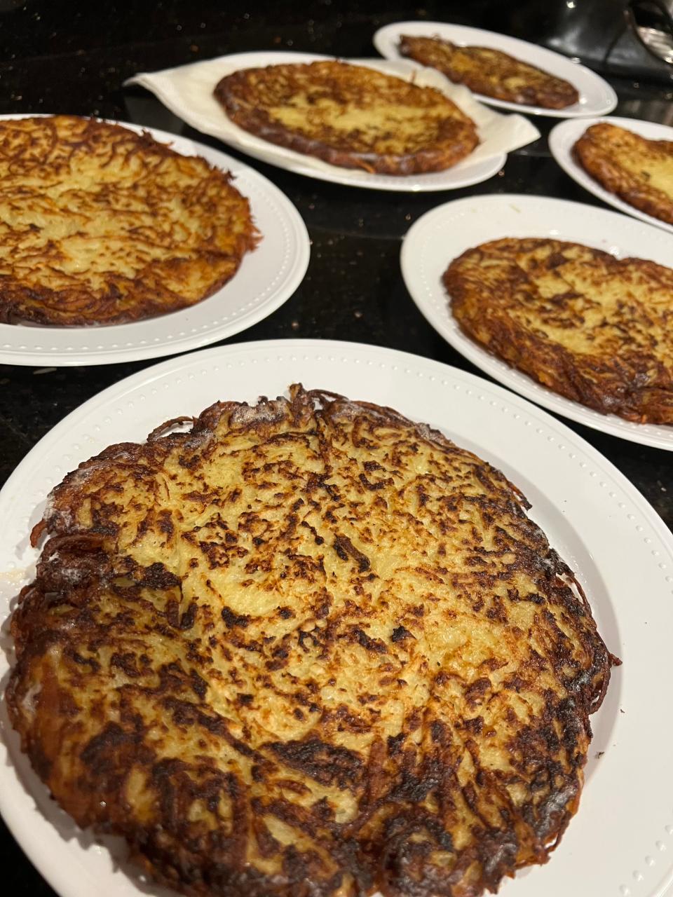 Levi Stein invites hundreds of his neighbors over to enjoy his Jumbo Stein Latkes during Hanukkah. Each 12- to 14-inch latke is meant to serve a family.