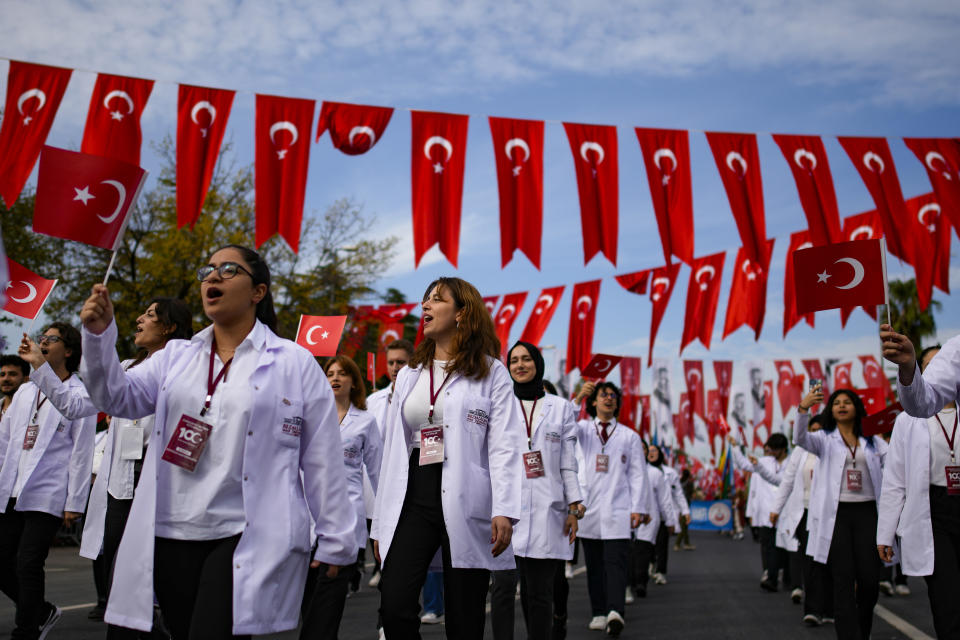 Medicine university students take part in a parade during celebrations marking the 100th anniversary of the creation of the modern secular Turkish Republic, in Istanbul, Turkey, Sunday, Oct. 29, 2023. Turkey is marking its centennial but a brain drain is casting a shadow on the occasion. Government statistics indicate that a growing number of the young and educated are looking to move abroad in hopes of a better life, mainly in Europe. (AP Photo/Emrah Gurel)