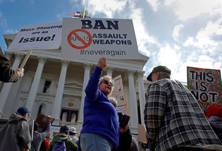 Protestors hold signs during a "March For Our Lives" demonstration demanding gun control in Sacramento, California, U.S. March 24, 2018. REUTERS/Bob Strong