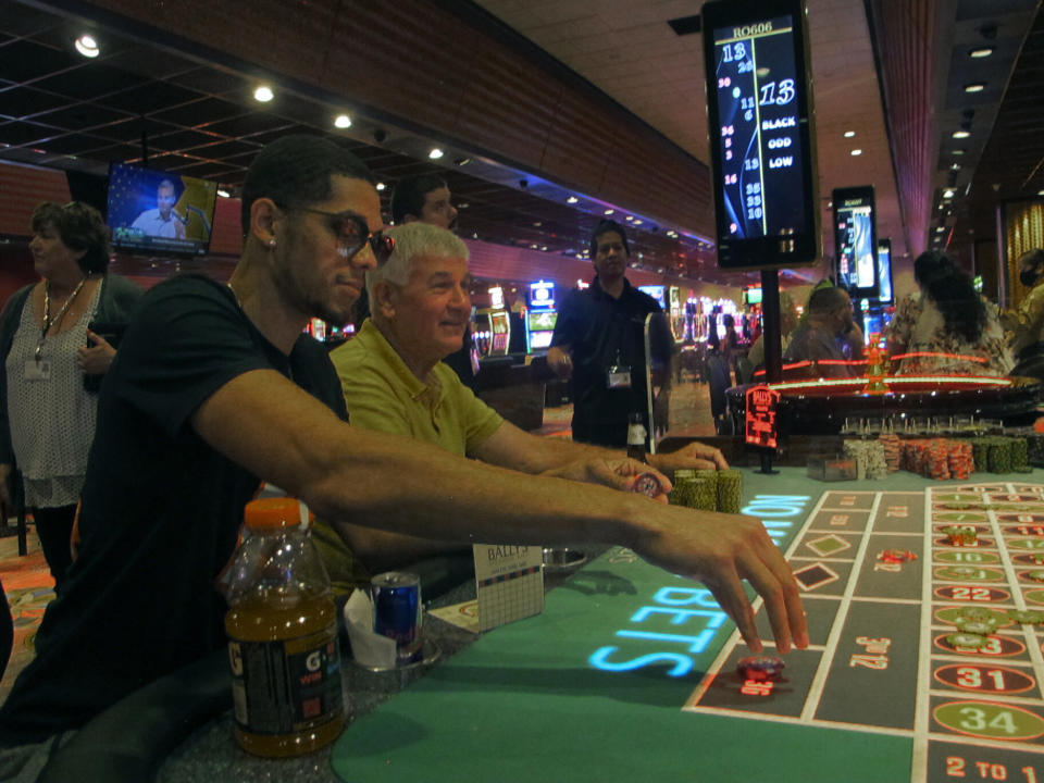 This June 23, 2021 photo shows gamblers playing roulette at Bally's casino in Atlantic City, N.J. Rhode Island-based Bally's Corp. is spending $100 million on renovations to the property, which ranks last among Atlantic City's nine casinos in terms of gambling revenue. (AP Photo/Wayne Parry)