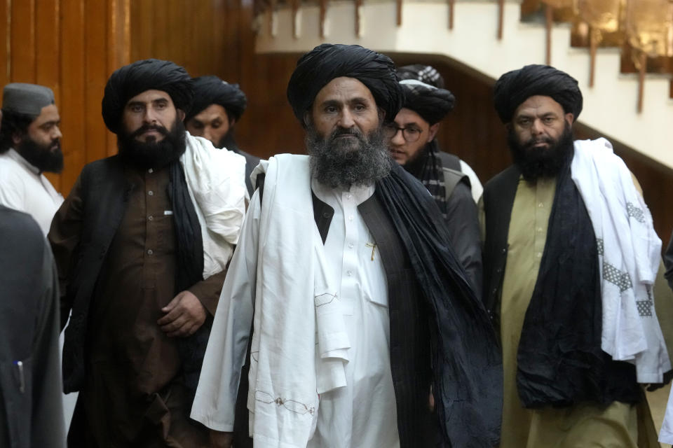 Mullah Abdul Ghani Baradar, center, Taliban-appointed Deputy Prime Minister, leaves after a document signing ceremony with the Abu Dhabi-based firm GAAC Solutions, in Kabul, Afghanistan, Thursday, Sept. 8, 2022. The Taliban signed a contract Thursday with GAAC Solutions that will provide flight guidance services which will include equipping the air service and staff training for the air services in three major airports including the capital Kabul. (AP Photo/Ebrahim Noroozi)