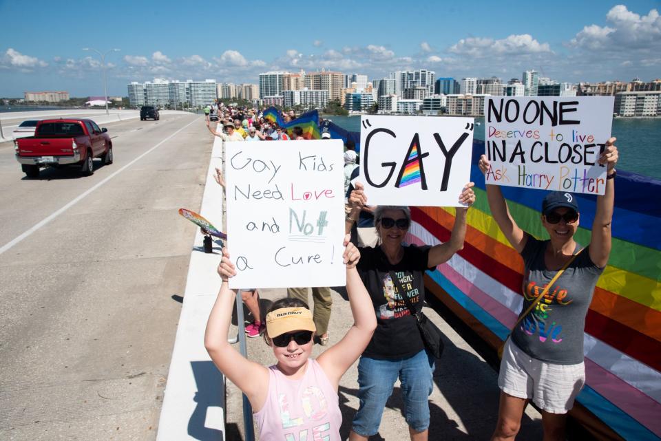 Hundreds of LGBTQ residents and their supporters rallied and waved a 700-foot LGBTQ pride flag over the Ringling Bridge in Sarasota recently in opposition to Florida's 'Don't Say Gay' bill. Gov. Ron DeSantis is poised to sign the legislation, but debate over the bill is certain to continue after the ink has dried on the governor's signature.