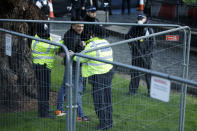 Police officers detain a man after he entered the grounds of the Houses of Parliament in London, Wednesday, Dec. 1, 2021. (AP Photo/David Cliff)