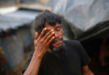 A Rohingya refugee washes himself outside his temporary shelter at Balukhali makeshift refugee camp in Cox's Bazar, Bangladesh, September 13, 2017. REUTERS/Danish Siddiqui