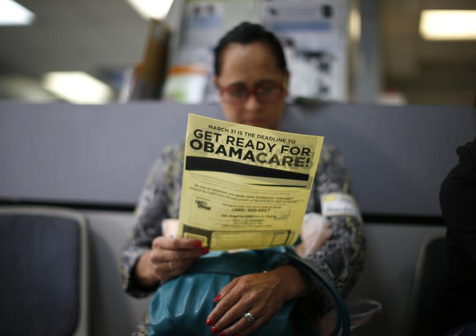 Arminda Murillo, 54, reads a leaflet at a health insurance enrollment event in Cudahy, California March 27, 2014. More than 6 million people have now signed up for private insurance plans under President Barack Obama's signature healthcare law known as Obamacare, reflecting a surge in enrollments days before the March 31 deadline, the White House said on Thursday. More than 1 million people have signed up for Obamacare in California, according to the Los Angeles Times. REUTERS/Lucy Nicholson (UNITED STATES - Tags: HEALTH POLITICS)