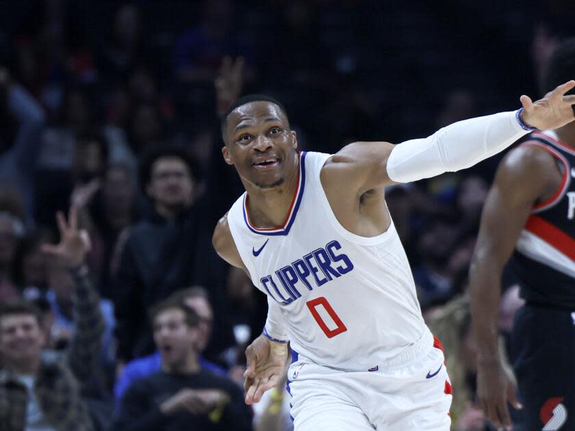 Russell Westbrook jumps and smiles.