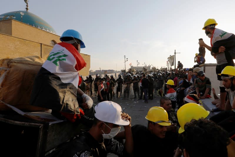 Demonstrators block Al Shuhada bridge during ongoing anti-government protests, in Baghdad