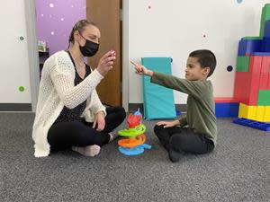 A child works on identification and communication skills at InBloom Autism Services.