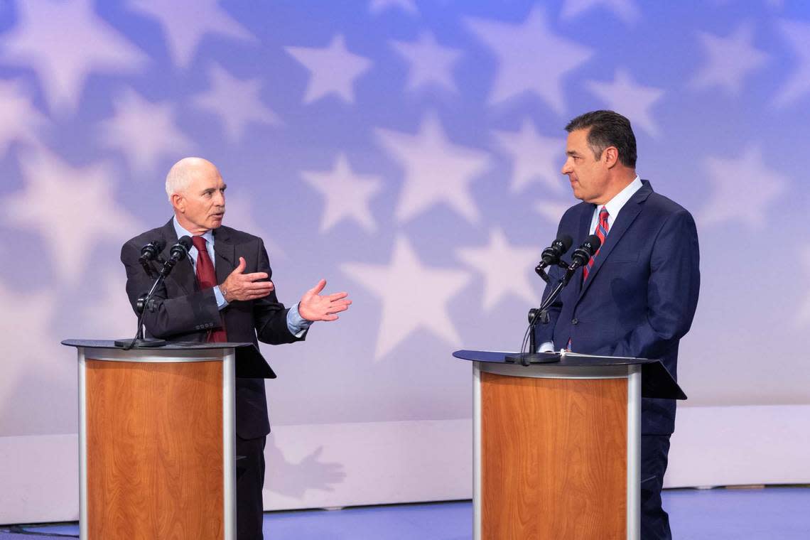 Democratic candidate Tom Arkoosh, left, and Republican candidate Raúl Labrador face off in a debate on Idaho Public Television in the race for Idaho attorney general on Monday, Oct. 3, 2022.