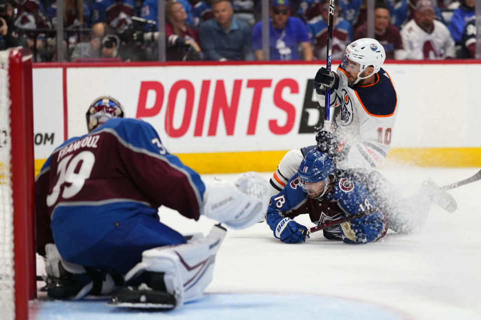 Edmonton Oilers center Derek Ryan (10) and Colorado Avalanche center Alex Newhook (18) tangle during the third period in Game 2 of the NHL hockey Stanley Cup playoffs Western Conference finals Thursday, June 2, 2022, in Denver. (AP Photo/Jack Dempsey)