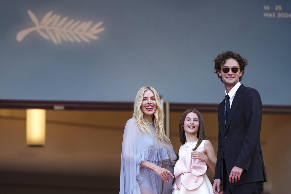 Sienna Miller, from left, Marlowe Sturridge, and Oli Green poses for photographers upon arrival at the premiere of the film 'Horizon: An American Saga' at the 77th international film festival, Cannes, southern France, Sunday, May 19, 2024. (Photo by Scott A Garfitt/Invision/AP)