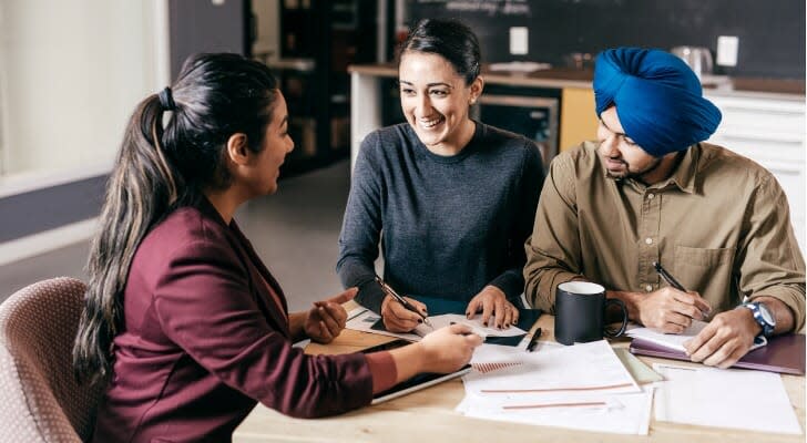 Wealthy couple talks with their wealth manager