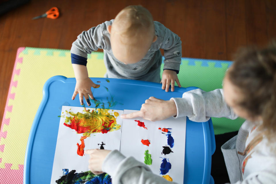 woman and baby finger painting