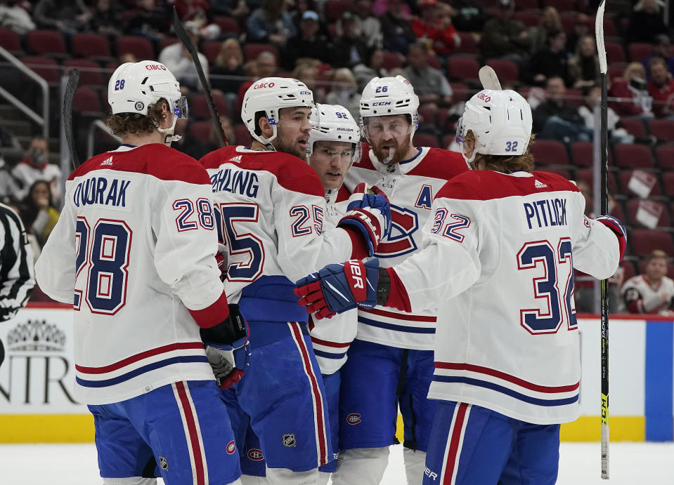 Montreal Canadiens' Christian Dvorak (28), Ryan Poehling (25), Jonathan Drouin (92), Jeff Petry (26), and Rem Pitlick (32) celebrate Poehling's goal during the second period of an NHL hockey game against the Arizona Coyotes, Monday, Jan. 17, 2022, in Glendale, Ariz. (AP Photo/Darryl Webb)