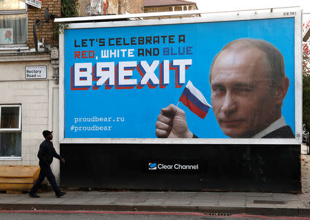 A man walks past a billboard poster in London, Britain, November 8, 2018. REUTERS/Peter Nicholls