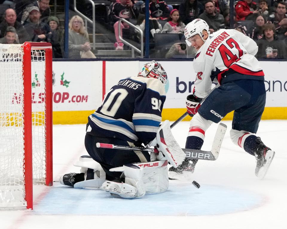 Dec. 201, 2023; Columbus, Ohio, USA; 
Columbus Blue Jackets goaltender Elvis Merzlikins (90) saves a shot by Washington Capitals defenseman Martin Fehervary (42) during overtime at Nationwide Arena on Thursday.