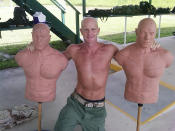 This undated photograph obtained by The Seattle Times shows FBI Special Agent Frederick W. Humphries posing with target dummies following a SWAT practice in an unknown location. The Times says Humphries sent the photograph to friend and Florida socialite Jill Kelley and others, including one of the paper's own reporters, in an email Sept. 9, 2010. (AP Photo/Special to The Seattle Times)