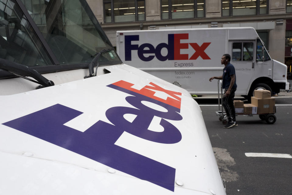 FILE - This Aug. 22, 2017  file photo shows FedEx trucks parked in New York. Companies with ties to the National Rifle Association have been dealing with increasing public pressure since the Parkland, Florida massacre that killed 17 people earlier this month. FedEx is the latest company prompted to make a statement, saying it “opposes assault rifles being in the hands of civilians” but strongly supports the right to own a firearm. The delivery service, which offers discounts to NRA members, said it is sticking with the organization. (AP Photo/Mark Lennihan, File)