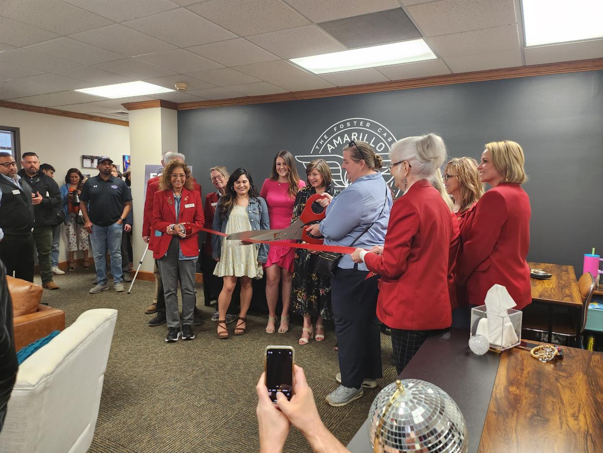 Amarillo Angels Executive Director Gwen Hicks celebrates the organization's seventh anniversary with a grand opening of its new office and ribbon cutting with the Amarillo Chamber of Commerce Wednesday afternoon.