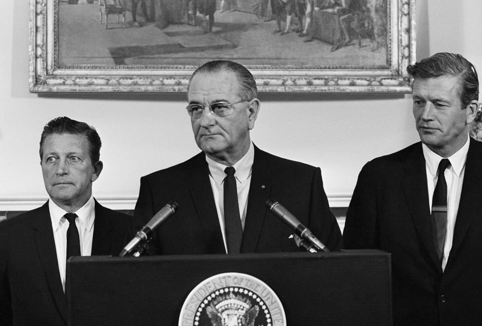 President Lyndon Johnson speaks to members of his advisory commission on civil disorders at the group's first meeting on July 29, 1967 at the White House, Washington. Otto Kerner, left, of Illinois, the chairman of the group and Mayor John Lindsay of New York (right) vice chairman. (AP)