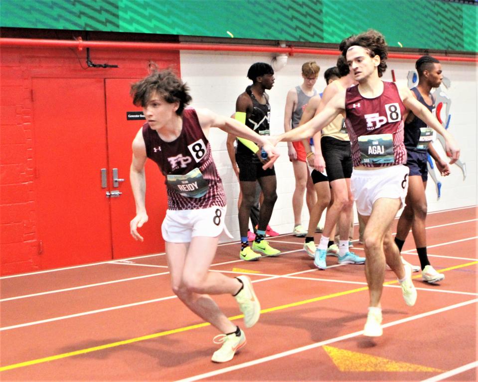 Fordham Prep is en route to a sixth-place medal in the boys championship 4x800 relay March 12, 2023 at the Nike Indoor Nationals at The Armory as Pelham's Ergi Agaj (r) hands the baton to Sean Reidy of White Plains.