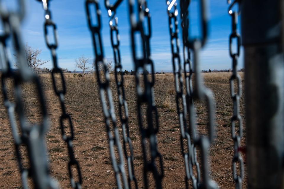 The site where Hughes Stadium once stood seen through a disc golf goal on March 15.