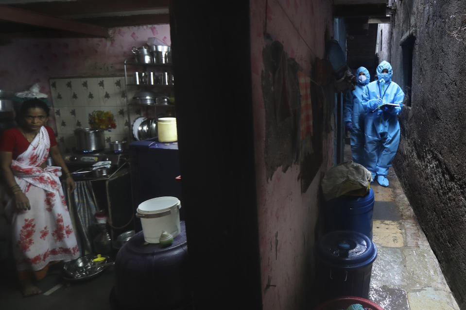 Health workers screen people for COVID-19 symptoms at a slum in Mumbai, India, Tuesday, July 14, 2020. (AP Photo/Rafiq Maqbool)