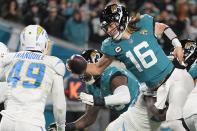 Jacksonville Jaguars quarterback Trevor Lawrence (16) leaps for a two-point conversion against the Los Angeles Chargers during the second half of an NFL wild-card football game, Saturday, Jan. 14, 2023, in Jacksonville, Fla. (AP Photo/Chris Carlson)