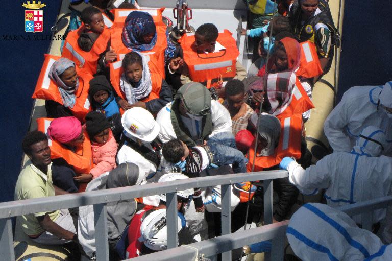 This handout picture released by the Italian Navy on May 4, 2015 shows women and children during a rescue operation of migrants off the coast of Sicily on May 3, 2015