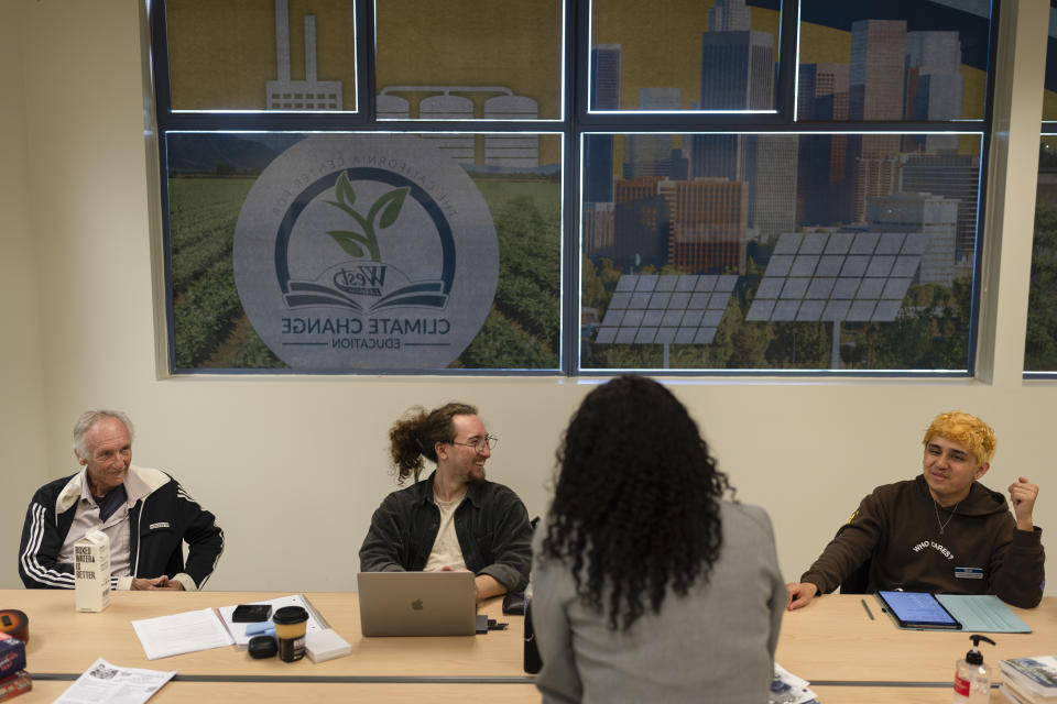 Student ambassadors Andrew Rodriguez, from right, Jaden Hugenberger and Jeff Kaisershot share a light moment at the California Center for Climate Change Education on the West Los Angeles College campus in Culver City, Calif., Tuesday, March 12, 2024. As students consider jobs that play a role in solving the climate crisis, they’re looking for meaningful climate training and community colleges are responding. (AP Photo/Jae C. Hong)