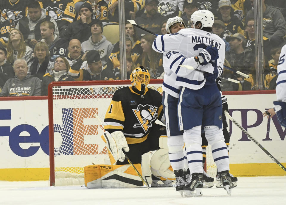 Toronto Maple Leafs right wing William Nylander celebrates a goal with center Auston Matthews near Pittsburgh Penguins goalie Casey DeSmith (1) during the second period of an NHL hockey game, Saturday, Nov. 26, 2022, in Pittsburgh. (AP Photo/Philip G. Pavely)