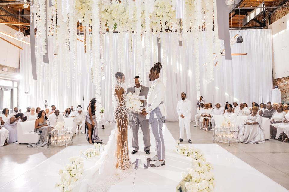 A bride and groom look at each other during their wedding ceremony.