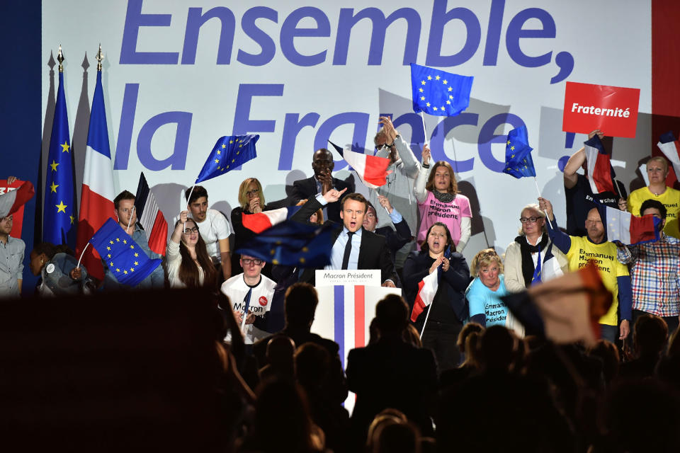 <p>French presidential election candidate for the En Marche ! movement, Emmanuel Macron (C) gestures as he delivers a speech during a campaign rally in Arras, northern France, on April 26, 2017 as he campaigns ahead of the run-off of the French presidential election. (Denis Charlet/AFP/Getty Images) </p>