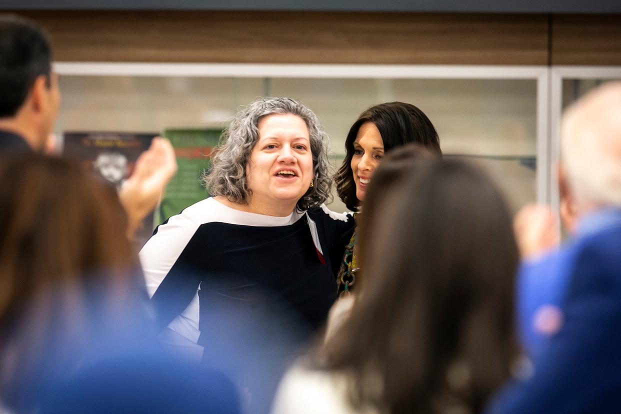 Christine Boge, left, is greeted by Susan Brennan, executive director of the ICCSD Foundation, during the annual Education is Everybody's Business ICCSD Foundation event, Friday, April 22, 2022, at City High School in Iowa City, Iowa.