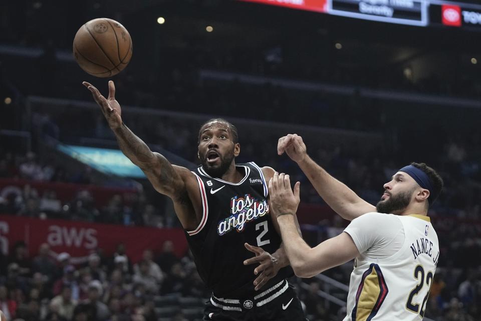 Los Angeles Clippers forward Kawhi Leonard, left, shoots as New Orleans Pelicans forward Larry Nance Jr. defends during the first half of an NBA basketball game Saturday, March 25, 2023, in Los Angeles. (AP Photo/Mark J. Terrill)