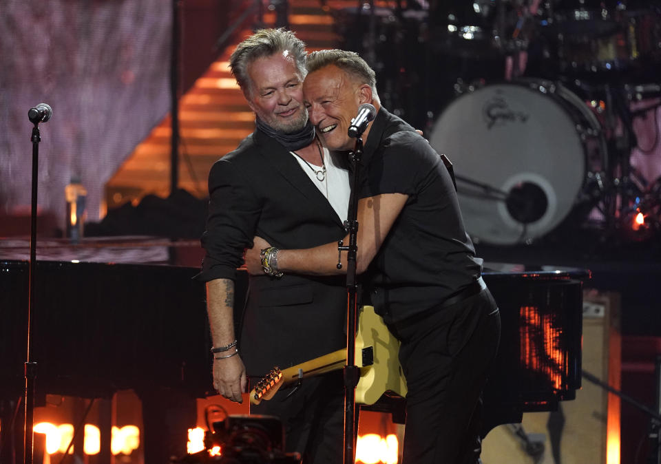 John Mellencamp, left, and Bruce Springsteen embrace during the Rock & Roll Hall of Fame Induction Ceremony on Saturday, Nov. 5, 2022, at the Microsoft Theater in Los Angeles. (AP Photo/Chris Pizzello)