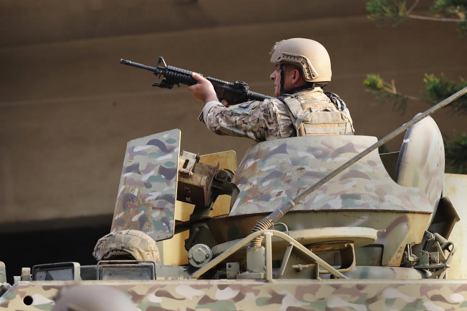 A Lebanese soldier fires in the air to separate protesters, during a clash with supporters of Prime Minister-designate Saad Hariri who stepped down on Thursday in Beirut, Lebanon, Thursday, July 15, 2021. Hariri says he is stepping down, nine months after he was named to the post by the parliament. He is citing "key differences" with the country's president, Michel Aoun. (AP Photo/Hussein Malla)