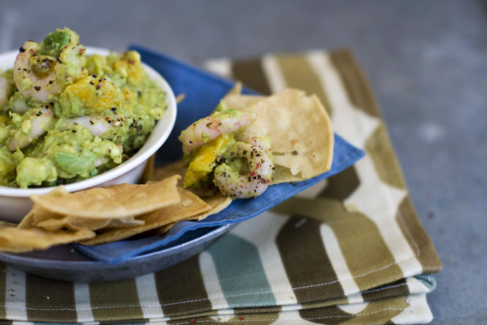 In this image taken on January 7, 2013, shrimp and mango guacamole is shown served in a bowl in Concord, N.H. (AP Photo/Matthew Mead)