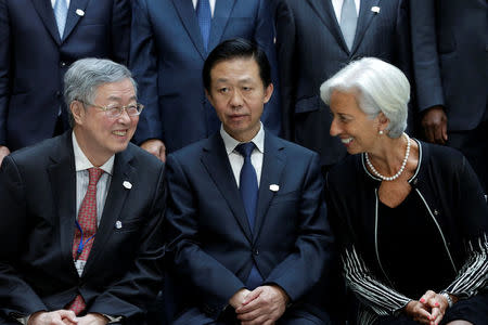 International Monetary Fund (IMF) Managing Director Christine Lagarde (R) chats with Chinese Finance Minister Xiao Jie (C) and Zhou Xiaochuan, Governor of the People's Bank of China, before G-20 family photo during the IMF/World Bank spring meetings in Washington, U.S., April 21, 2017. REUTERS/Yuri Gripas